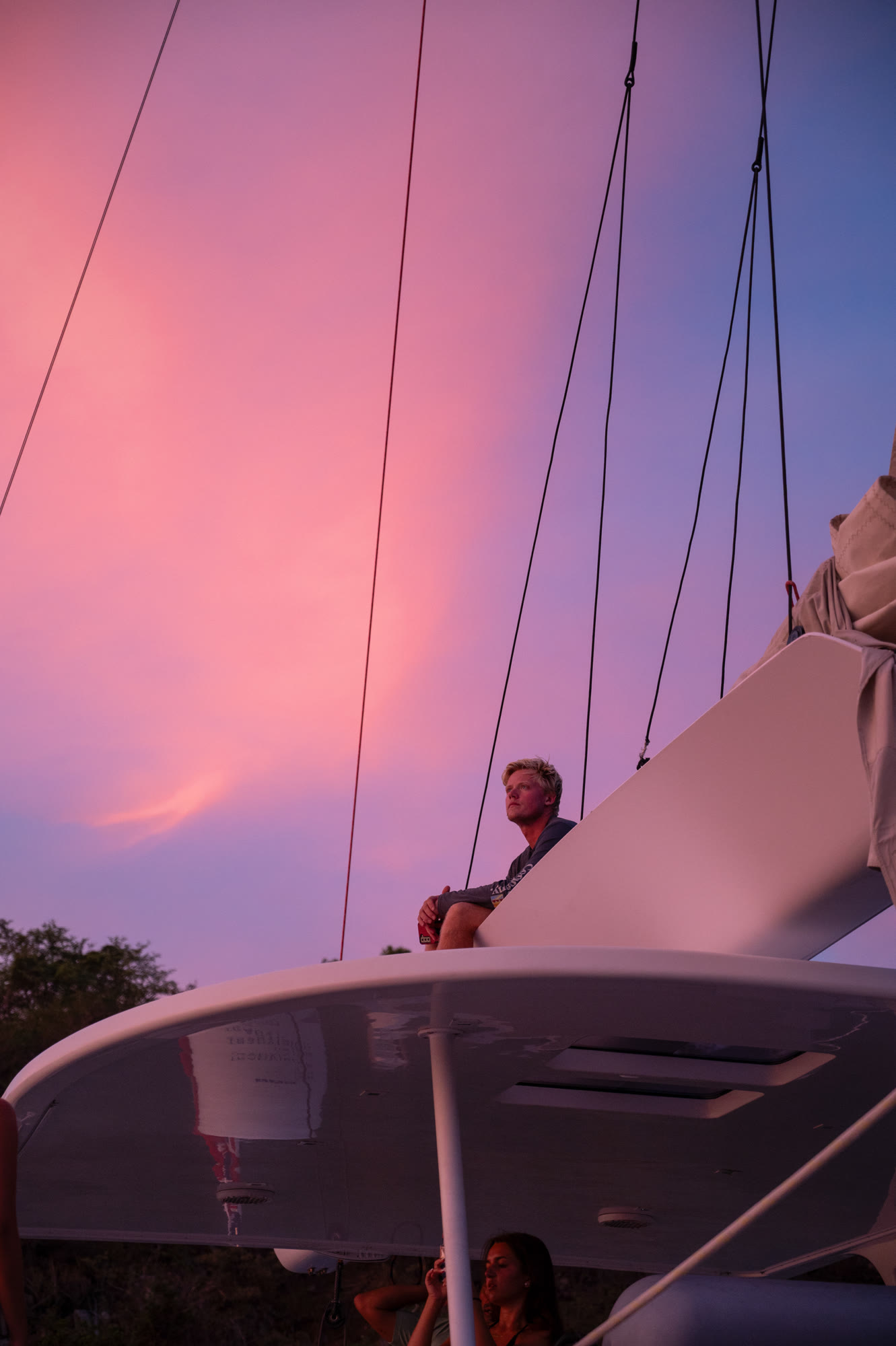 At the helm, pink sky